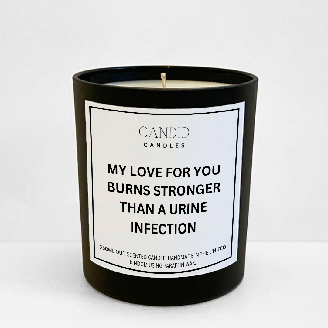 Scented black candle with funny label saying'My love for you burns stronger than a urine infection'