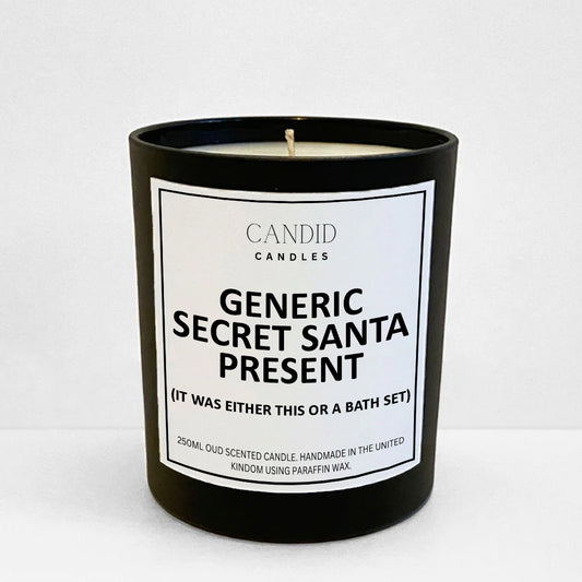 Festive and funny candle with label 'Generic Secret Santa Present' on black glass jar