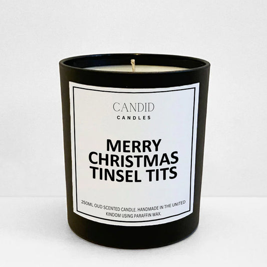 funny handmade candle with label printed saying'Merry Christmas Tinsel Tits' on black jar