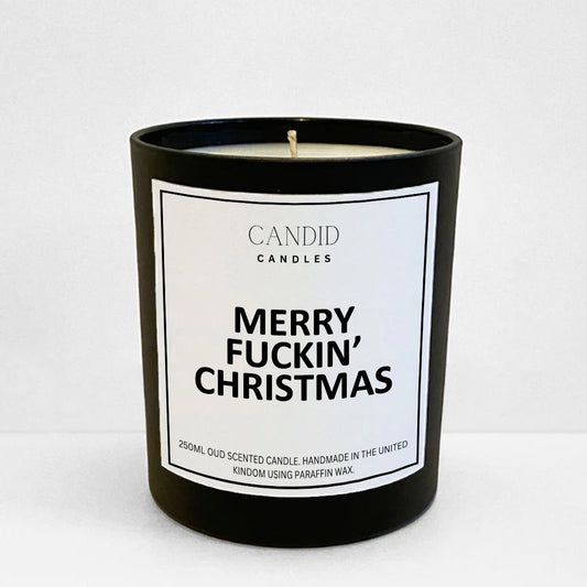 Festive funny scented candle with 'Merry Fuckin' Christmas' printed on black glass jar