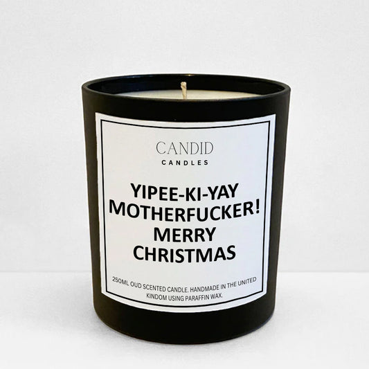 Funny and festive candle with film quote 'Yipee-Ki-Yay Motherfucker' printed on a black jar