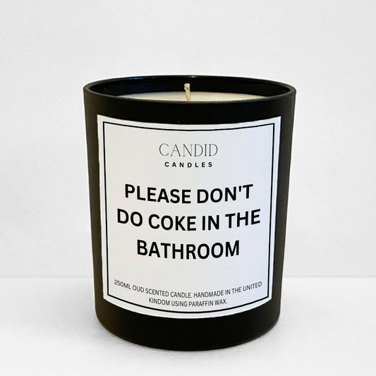 Funny scented candle in black jar with white label saying 'Please don't do coke in the bathroom' 