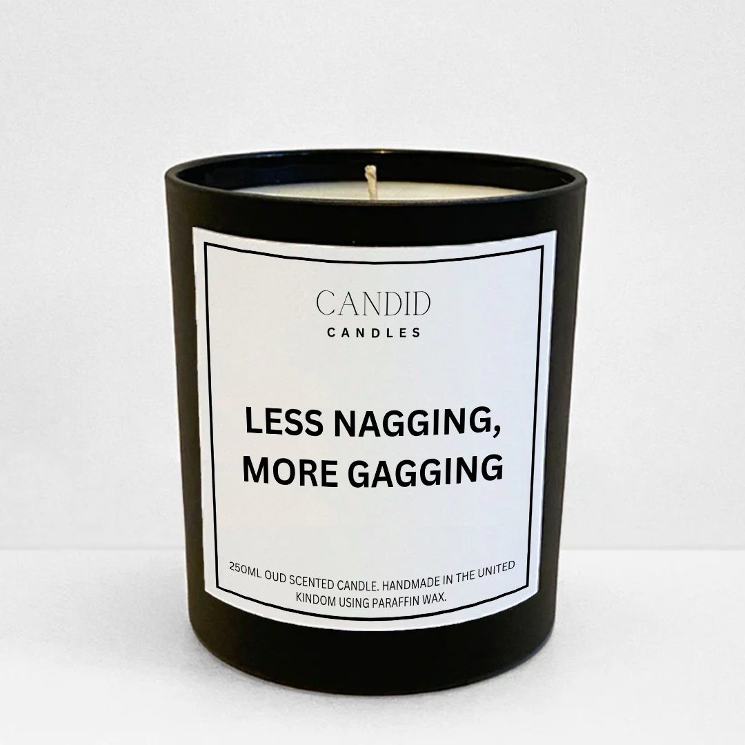 Funny oud candle in black jar with white label saying "Less Nagging, More Gagging"