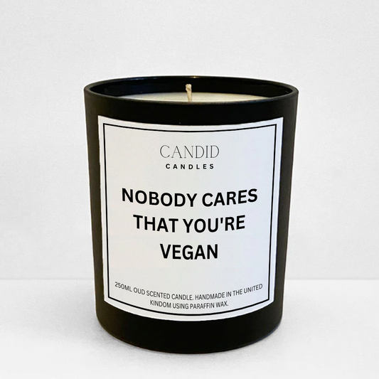 Funny white labelled "Nobody Cares That You're Vegan" scented candle in black glass container